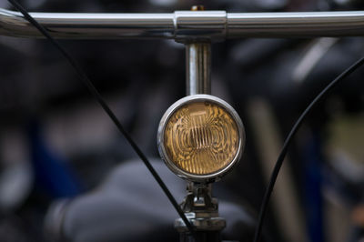 Close-up of headlight on bicycle handle