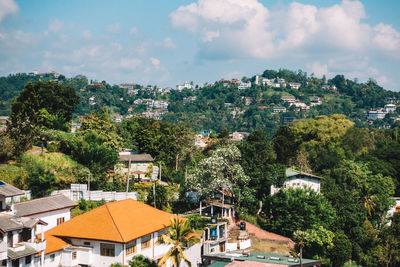 Houses and trees against sky