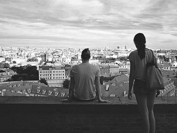 Rear view of woman looking at cityscape