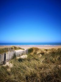 Scenic view of sea against clear blue sky