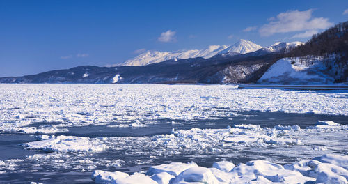 Scenic view of frozen lake against mountain range