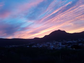 Scenic view of silhouette mountains against sky at sunset