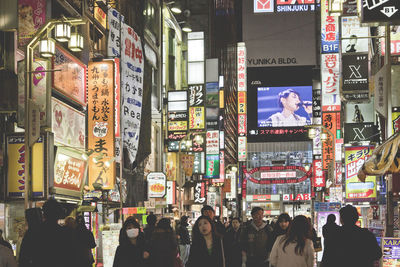 People walking on street in city at night