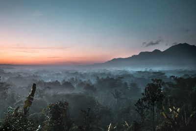 Scenic view of mountains against sky at sunset