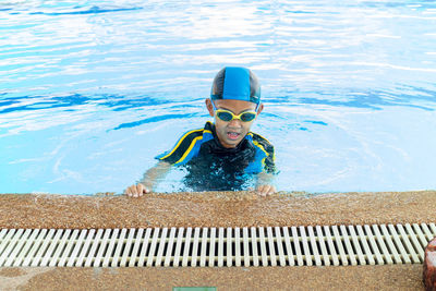 High angle view of boy swimming in pool