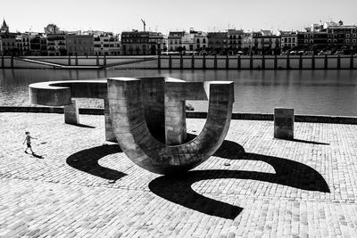 Shadow of railing on river
