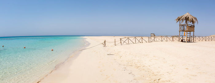 Scenic view of beach against clear sky