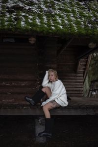 Portrait of young woman sitting on steps