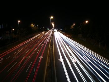 High angle view of light trails on road at night