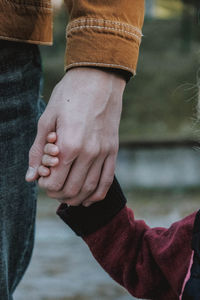 Close-up of man holding hands