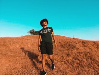 Full length of man on field against clear sky
