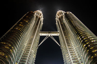 Low angle view of illuminated buildings against sky at night