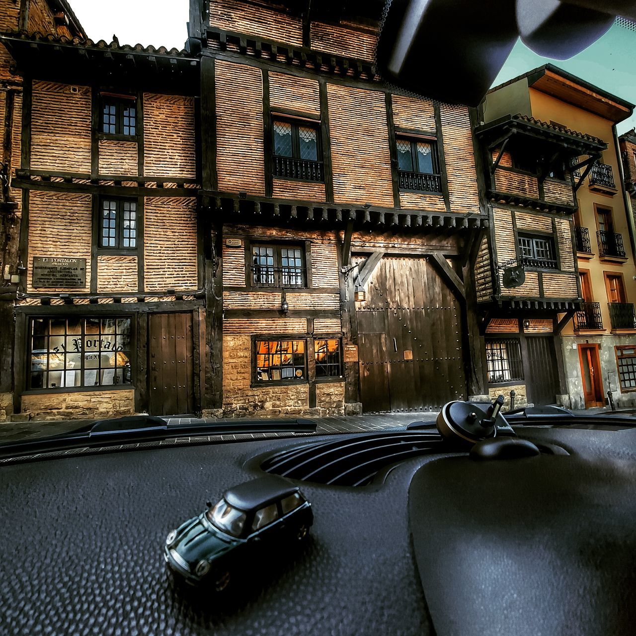 CAR ON STREET BY BUILDINGS