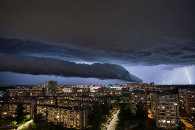 High angle view of illuminated city against sky at night