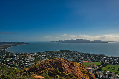 High angle view of townscape by sea against sky