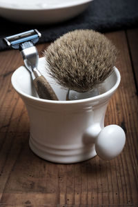 Close-up of shaving equipment on table