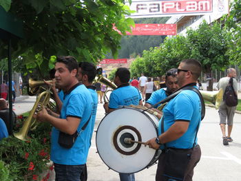 People standing against plants in city