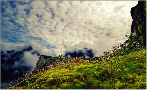 Scenic view of mountains against cloudy sky