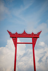 Low angle view of cross against sky