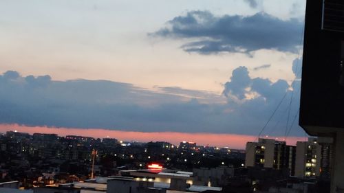 High angle view of illuminated buildings against sky at sunset