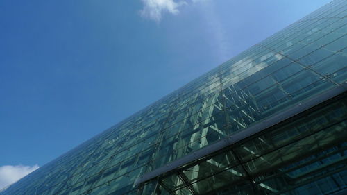 Low angle view of modern building against blue sky