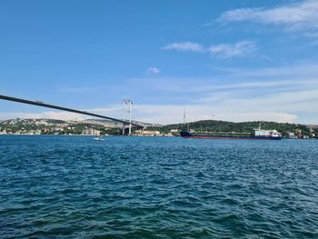 Bridge over sea against sky in city