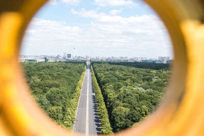 Scenic view of cityscape and street seen through hole