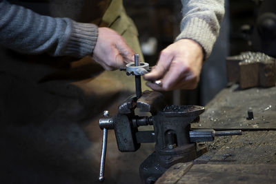 Professional blacksmith working with metal at forge.handmade, craftsmanship , blacksmithing concept