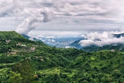 Scenic view of sea and mountains against sky