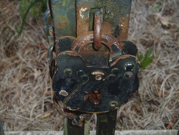 Close-up of padlock on rusty metal