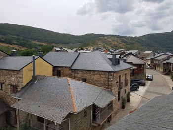 High angle view of houses in town against sky