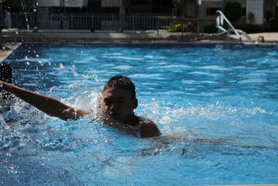 Boy swimming in pool