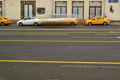 Yellow car on city street