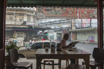 Woman sitting on chair in cafe