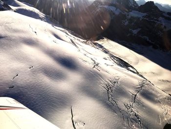 High angle view of snow covered mountain against sky