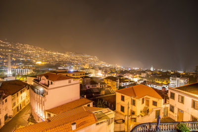 High angle view of illuminated buildings in city at night