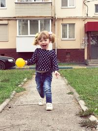 Full length of cute girl standing outdoors