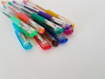 High angle view of colored pencils on white background