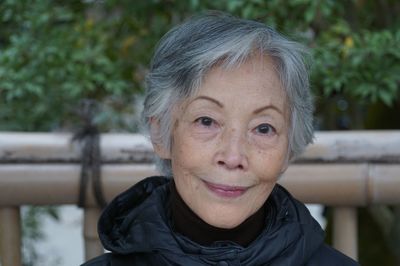 Close-up portrait of senior woman sitting outdoors