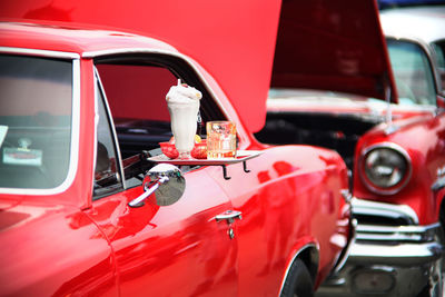 Drink in plate at car window