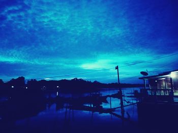 Scenic view of lake against blue sky at dusk