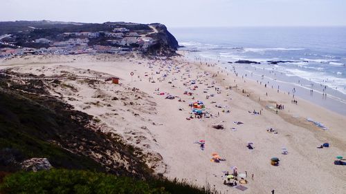 High angle view of people on beach against clear sky