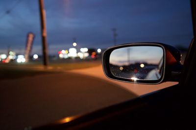 Reflection of car on side-view mirror