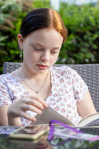 Portrait of young woman using mobile phone