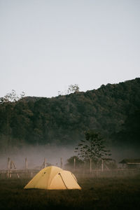 Tent on field against clear sky