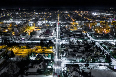 High angle view of city lit up at night