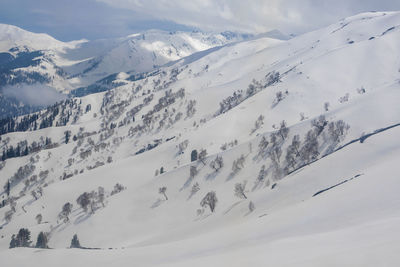 Scenic view of snow covered mountains against sky