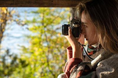 Portrait of woman photographing