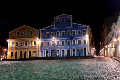 Illuminated building against sky at night