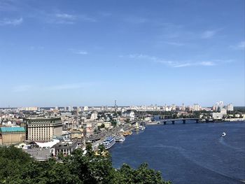 High angle view of buildings and sea against sky